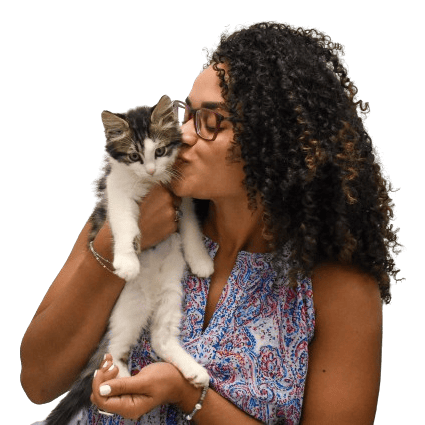 Adorable woman holding and kissing a kitten, promoting pet adoption and care.