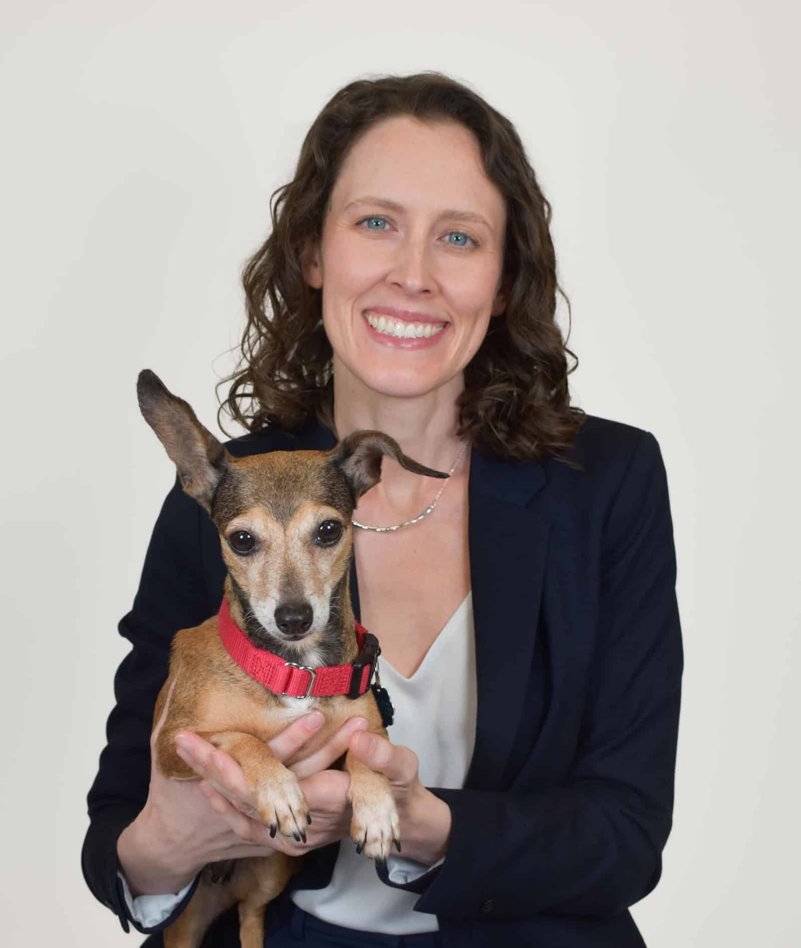 Woman holding small dog at Peggy Adams Animal Rescue.