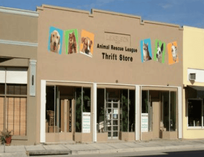Animal rescue league thrift store with pet images on the signboard.